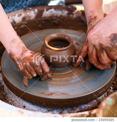 Hands working on pottery wheel 15095685