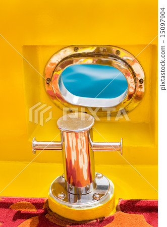 Bollard and sea window on yellow boat 15097904
