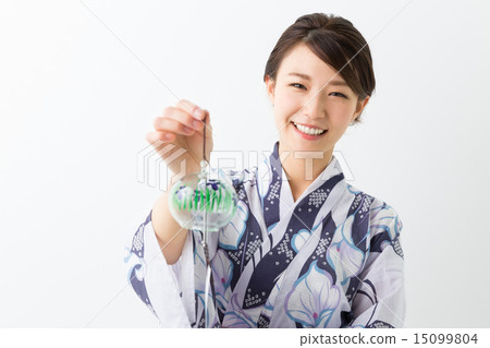 A woman with a wind chime wearing a yukata A woman with a wind chime wearing a yukata 15099804