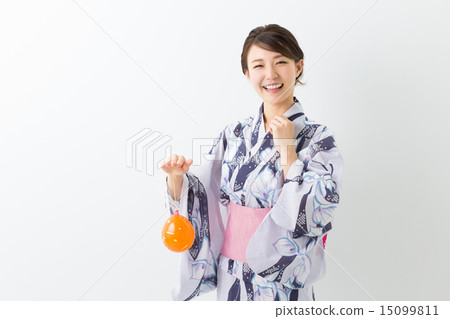 A woman with a yo-yo wearing a yukata A woman with a yo-yo wearing a yukata 15099811