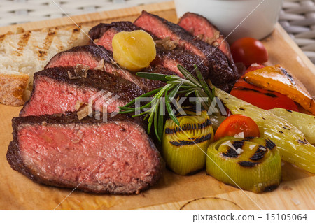 Grilled beef steak on wooden board 15105064