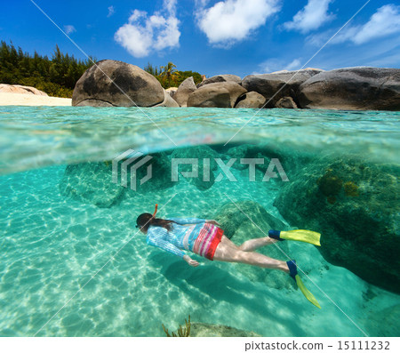 Woman snorkeling in tropical water 15111232