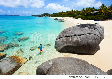 Woman with snorkeling equipment at tropical beach 15111235