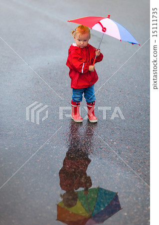 Toddler girl with colorful umbrella on rainy day 15111735