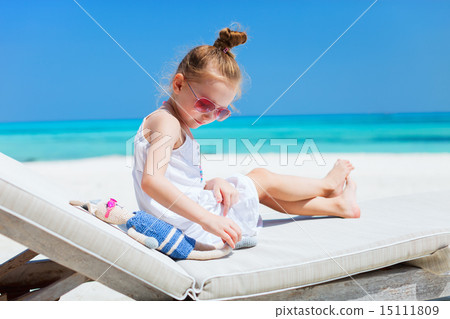 Little girl with toy at beach Little girl with toy at beach 15111809