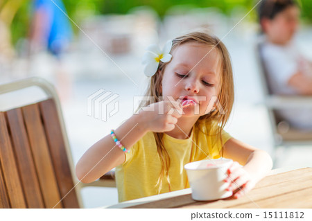 Little girl eating ice cream Little girl eating ice cream 15111812