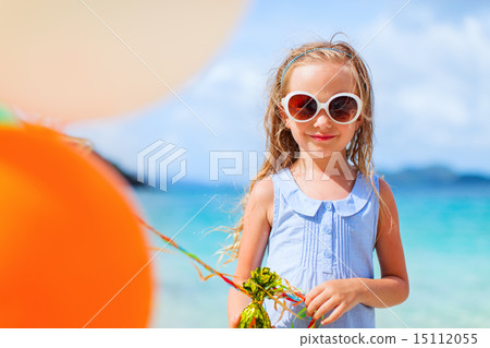 Little girl with balloons at beach Little girl with balloons at beach 15112055