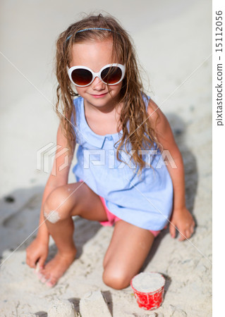 Little girl playing at beach Little girl playing at beach 15112056