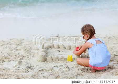 Little girl playing at beach Little girl playing at beach 15112057