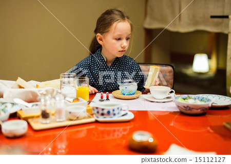Little girl eating breakfast in Japan 15112127