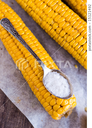 boiled yellow corn and a teaspoon of salt,close up boiled yellow corn and a teaspoon of salt,close up 15121492