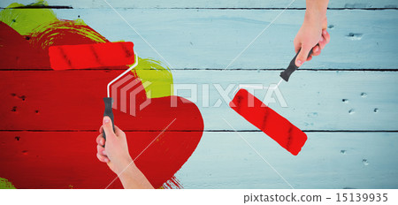 Composite image of handyman holding paint roller 15139935