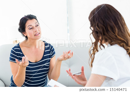 Depressed woman talking with her therapist 15140471