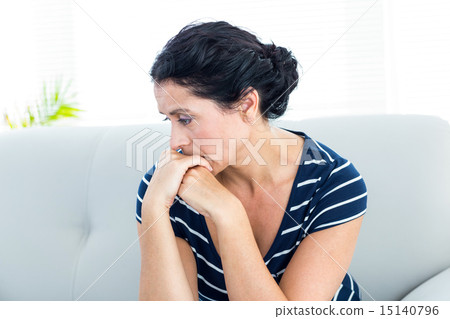 Unhappy woman sitting on the couch 15140796