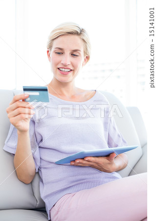 Pretty blonde woman doing online shopping 15141001