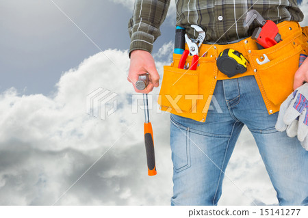 Composite image of manual worker holding gloves and hammer Composite image of manual worker holding gloves and hammer 15141277