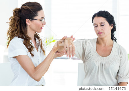 Therapist holding her patients arm 15141673