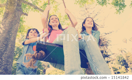 Kids pushing mother on swing 15141842