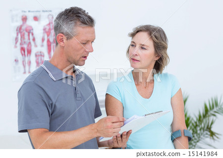 Woman using crutch and talking with her doctor Woman using crutch and talking with her doctor 15141984