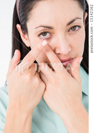 Brunette putting her contact lens 15142162