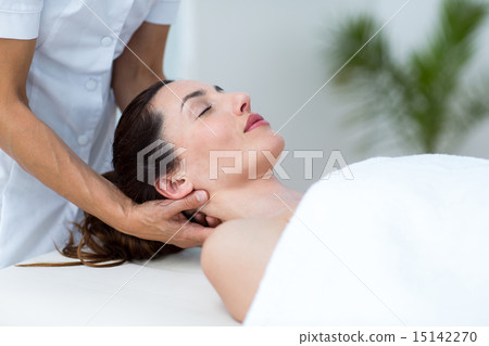 Physiotherapist doing neck massage Physiotherapist doing neck massage 15142270