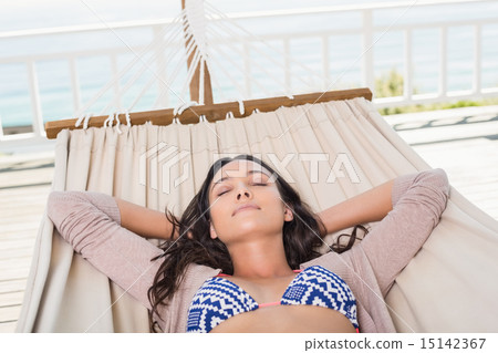 Pretty brunette relaxing on a hammock Pretty brunette relaxing on a hammock 15142367