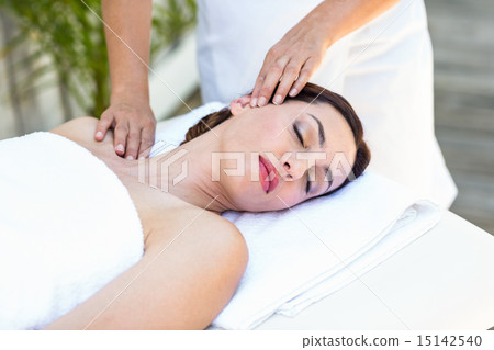 Brunette receiving neck massage 15142540