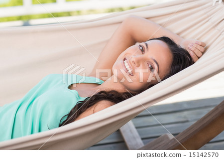 Pretty brunette relaxing on a hammock Pretty brunette relaxing on a hammock 15142570