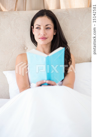 Pretty brunette reading on bed Pretty brunette reading on bed 15142581