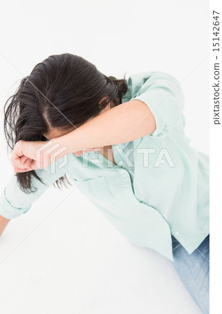 Sad woman sitting on the floor and hiding her face 15142647