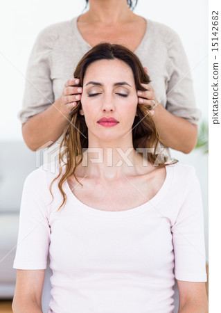 Calm woman receiving reiki treatment 15142682
