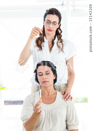 Woman being hypnotized to quit smoking 15143109