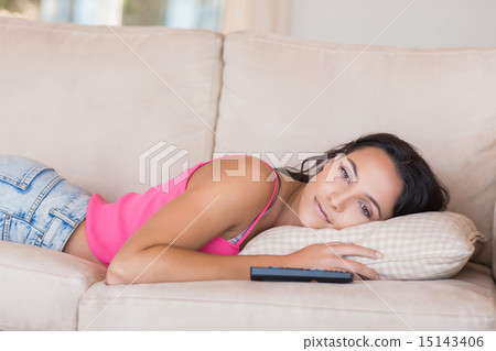 Pretty brunette relaxing on the couch 15143406