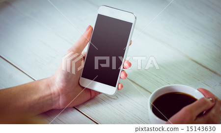 Woman using her smartphone with coffee Woman using her smartphone with coffee 15143630
