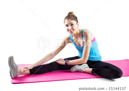 Fit woman stretching on exercise mat 15144137