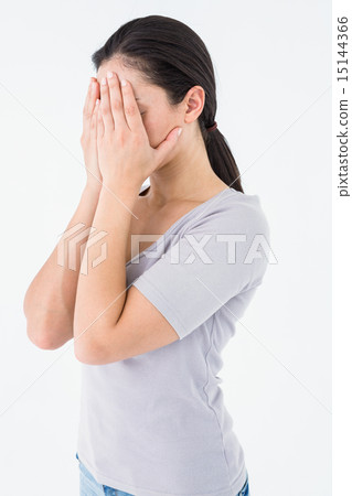 Sad brunette hiding her face 15144366