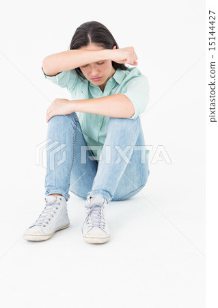 Sad woman sitting on the floor and hiding her face 15144427