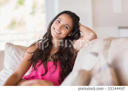 Pretty brunette relaxing on the couch Pretty brunette relaxing on the couch 15144497