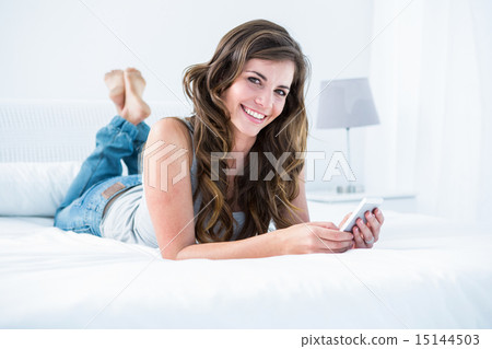 Attractive woman using her smartphone 15144503