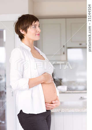 Pregnant woman holding her bump 15144504
