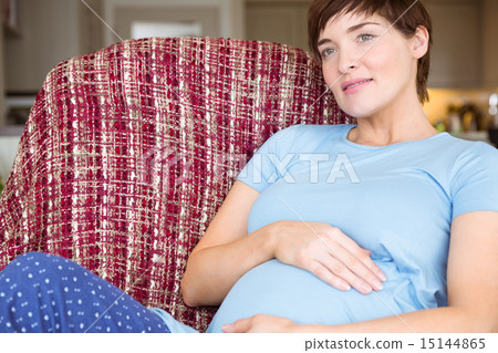 Pregnant woman relaxing on the couch 15144865