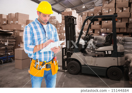 Composite image of manual worker writing on clipboard Composite image of manual worker writing on clipboard 15144884