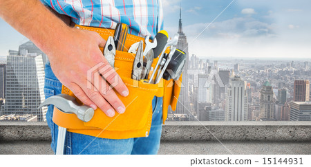Composite image of midsection of handyman wearing tool belt Composite image of midsection of handyman wearing tool belt 15144931