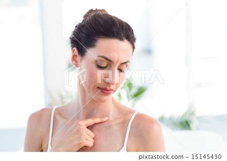 Brunette touching her clavicle 15145430