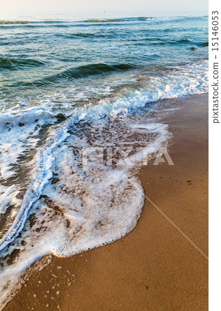Sea waves in the white foam on the sandy beach. Sea waves in the white foam on the sandy beach. 15146053