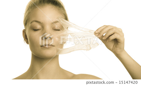 girl removing facial peel off mask girl removing facial peel off mask 15147420