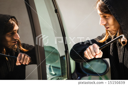 Transportation and crime- thief breaking car window 15150839