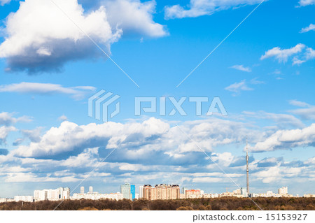 white clouds in blue spring sky over city 15153927