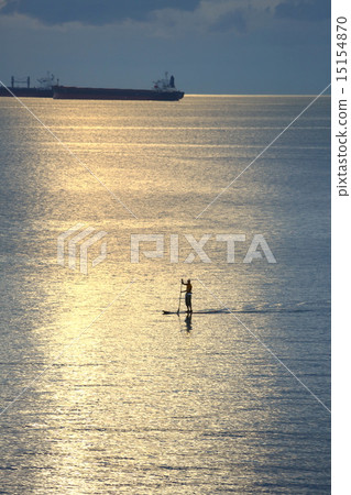 A person riding a paddle board in the sunset - Paddle board in Sunset 15154870