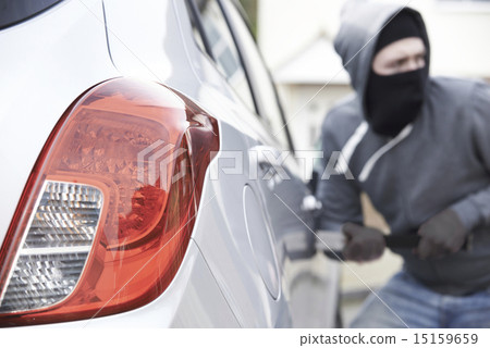 Masked Man Breaking Into Car With Crowbar Masked Man Breaking Into Car With Crowbar 15159659